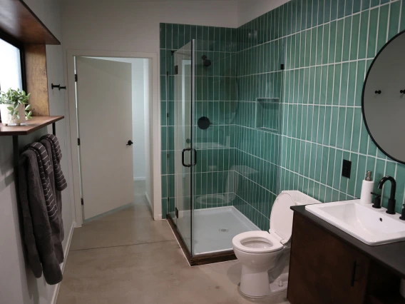 University rowhouse bathroom featuring walk-in glass shower