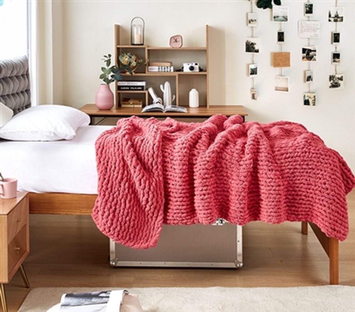 dorm room with pink blanket