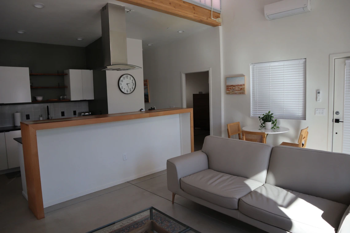 University rowhouse living room interior featuring couch and kitchen